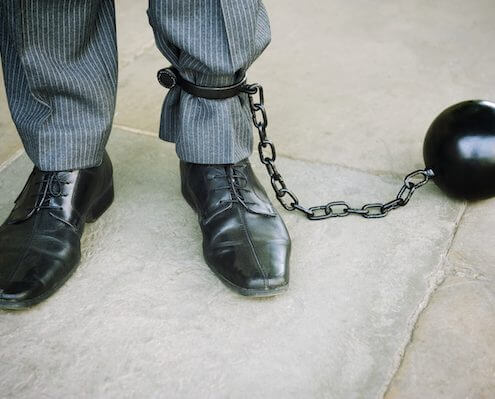 ball and chain on a businessman